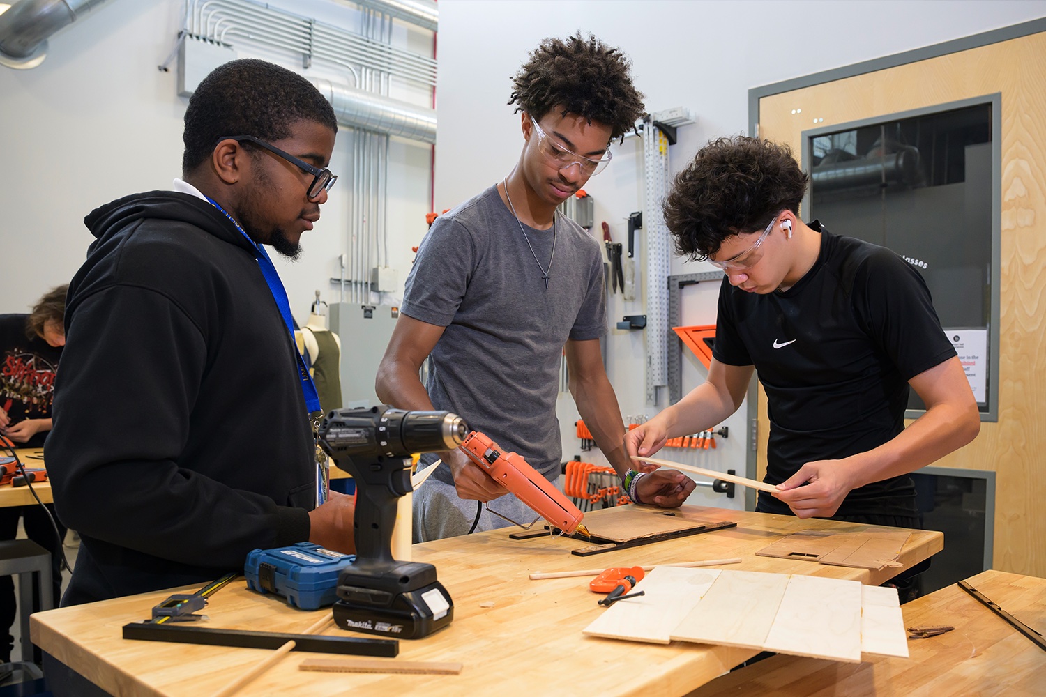 Three students work together on an engineering design project.