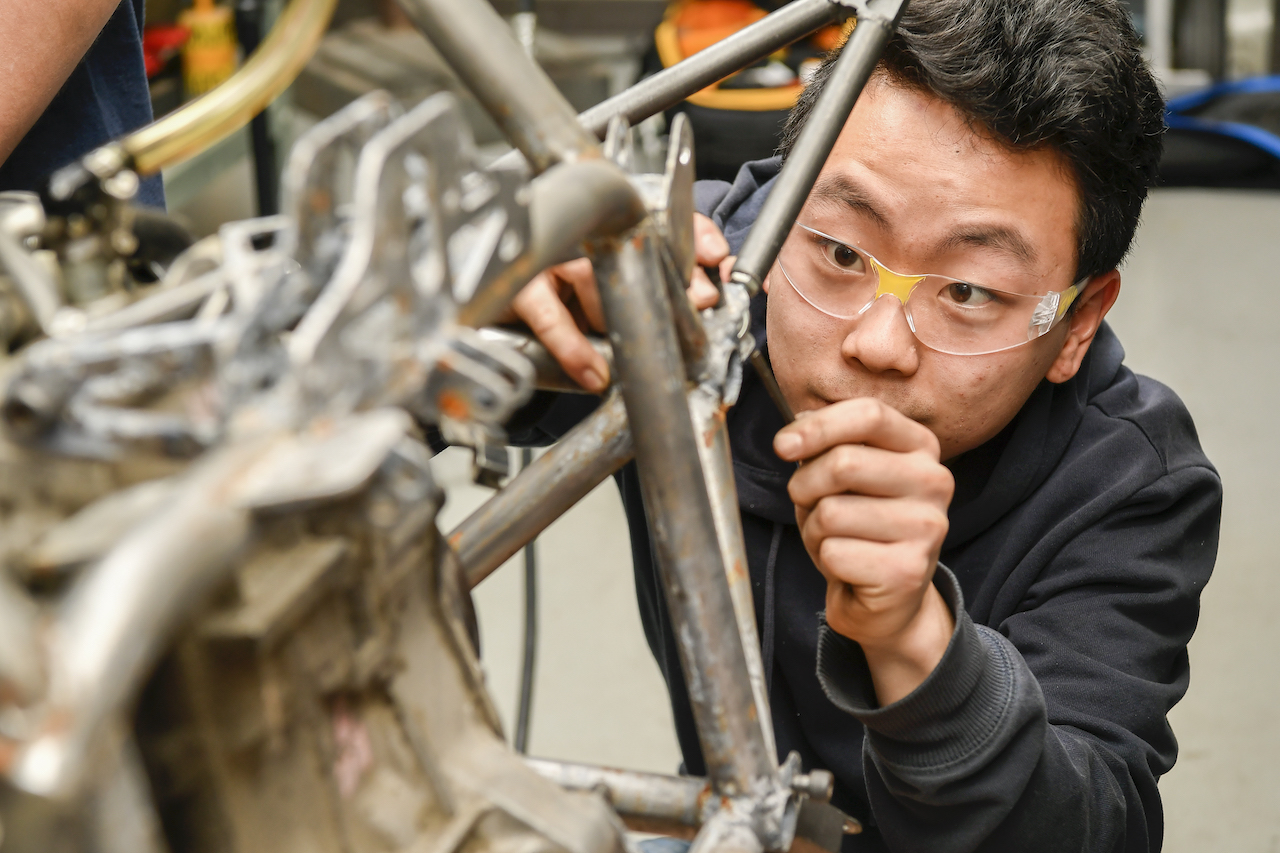 male university of delaware college of engineering student working on a project