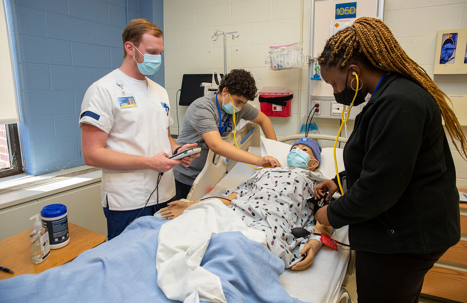 Nursing Students working with a life-size model.