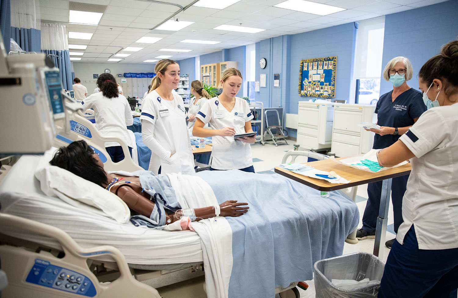 Nursing Students practice in a classroom setting.