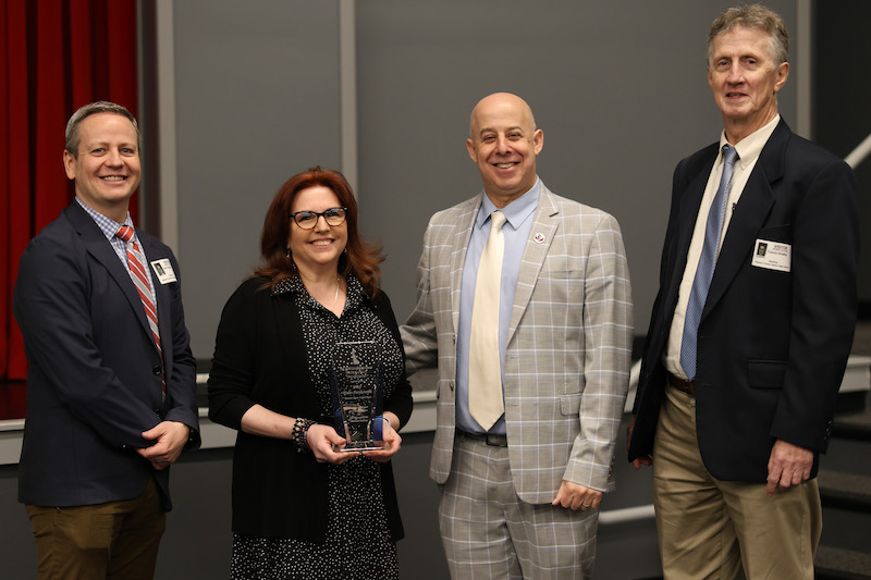 Group photo of Stacy Walls-Bartkowski, a ninth grade social studies educator at Newark Charter Senior High School and 2024 recipient of the Governor’s Award for Excellence in Civics Education, poses for a photo with Scott Abbott (left), Sam Golder (center right) and Fran O’Malley (right).