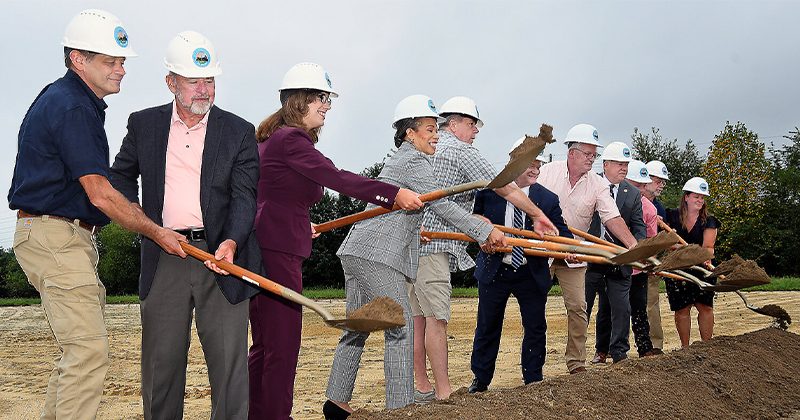 Local, state and federal officials toss shovelfuls of dirt during the Aug. 20 groundbreaking for the Harrington Industrial Park.