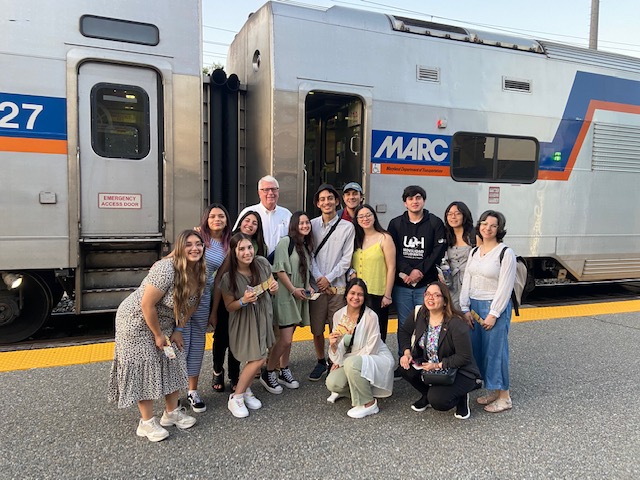 UD alumnus and CANR executive in residence Ed Kee (back row, left) poses for a photograph on a train platform with 12 Chilean scholars.