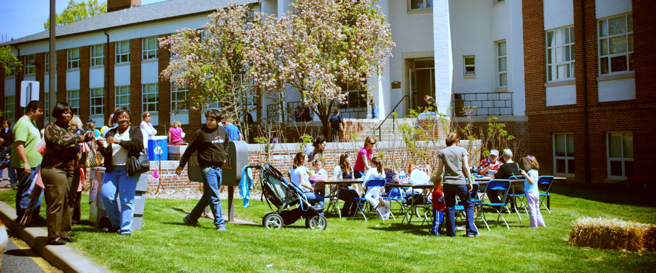 Photo of the outside of Townsend Hall on University of Delaware south campus during a past Ag Day event with a lot of people and balloons