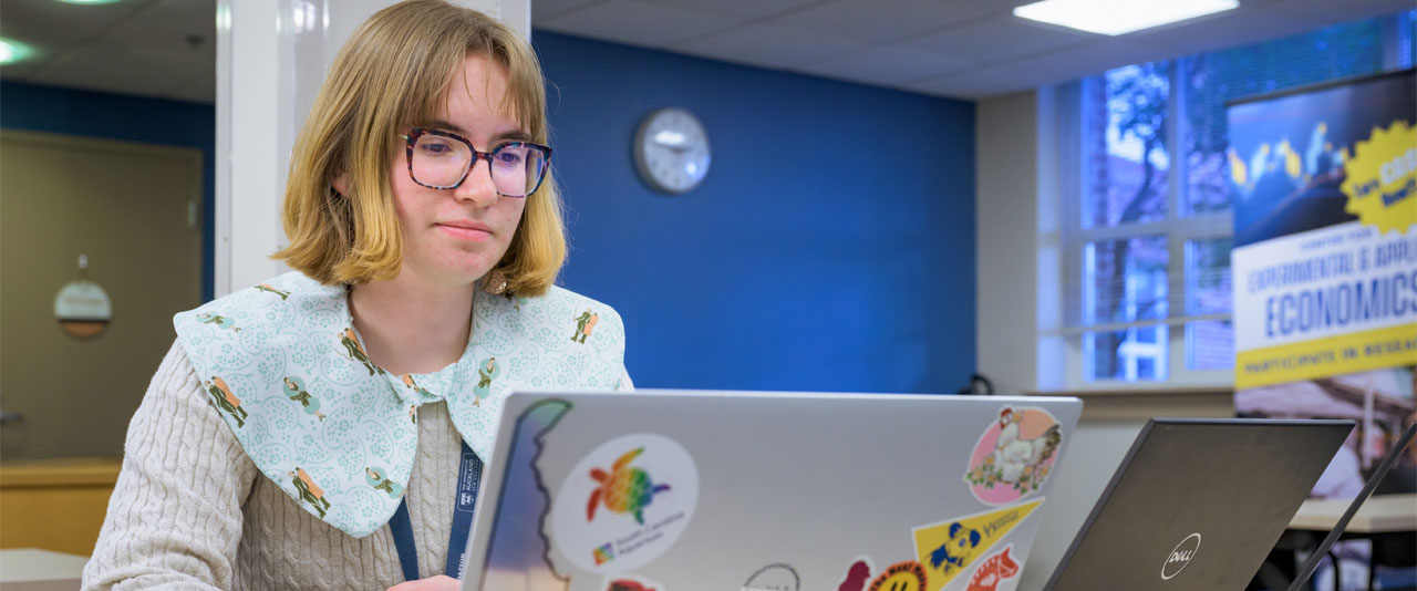 Emma Abrams works on her laptop