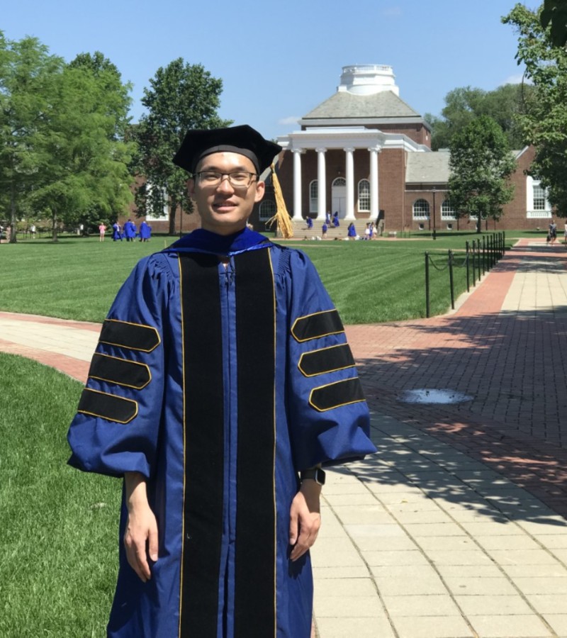 Photo of Yunkiao Cai in his graduate attire at the University of Delaware