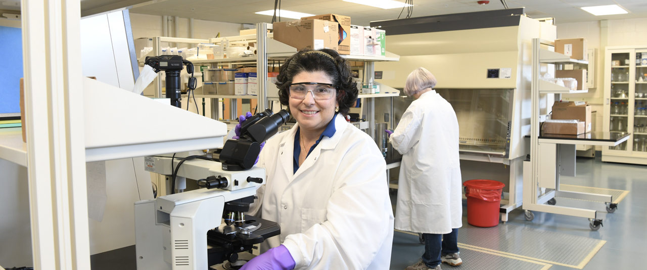 Dr. Nanette Olmeda-Geniec at microscope