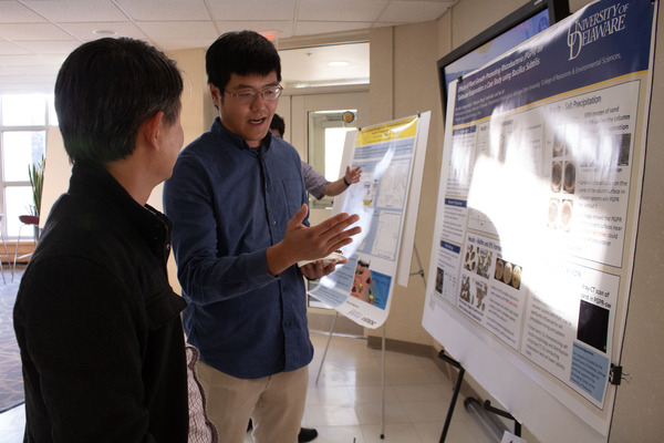 Jing Yan shares his research with a University of Delaware guest.