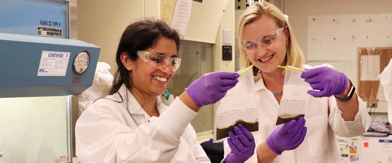 Student in labcoat taking samples