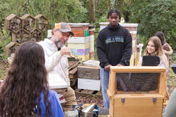 students in ANFS111 learn about poultry production from Dr. Ryan Arsenault and apiary and bee maintenance from Dan Borkoski.