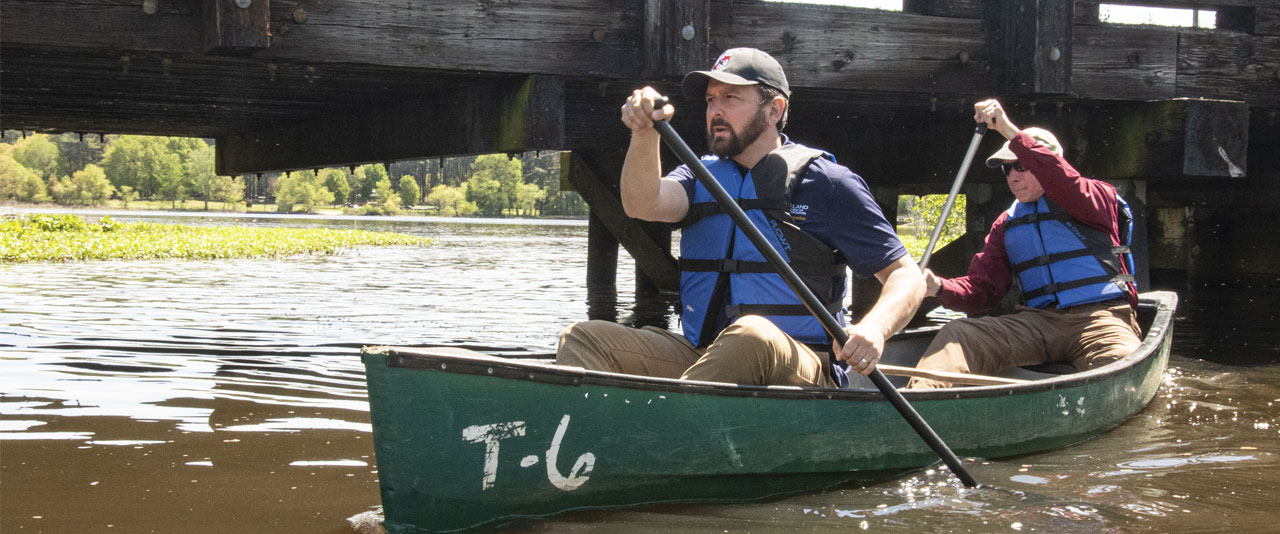 Josh Kurtz paddles a canoe.