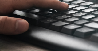 Someone typing on a keyboard