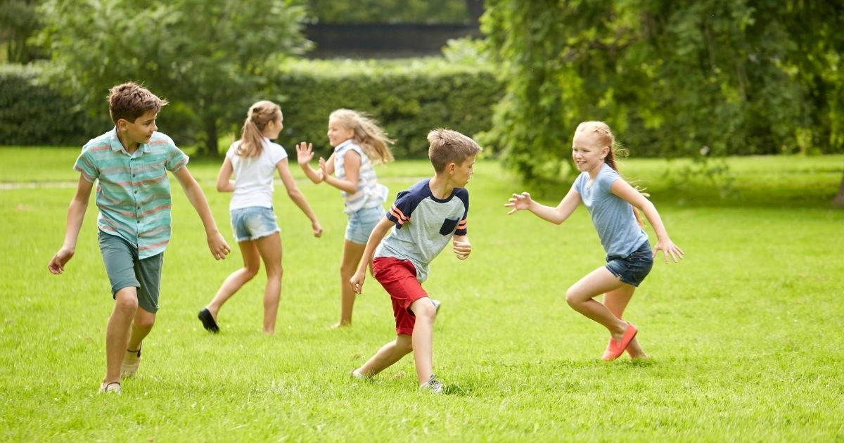 A group of children running around together outside
