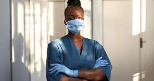 A african american female wearing a mask in a medical facility