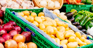 A variety of fruits and vegetables in bins