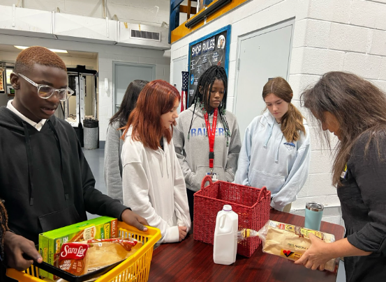 A group of students organizing a collection of groceries. 