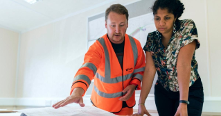 A contractor and a client looking at plans,