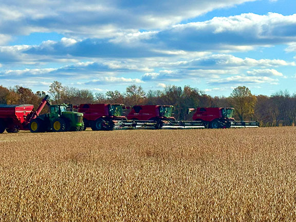 Three CASE combines in a row parked in a soybean field in the fall
