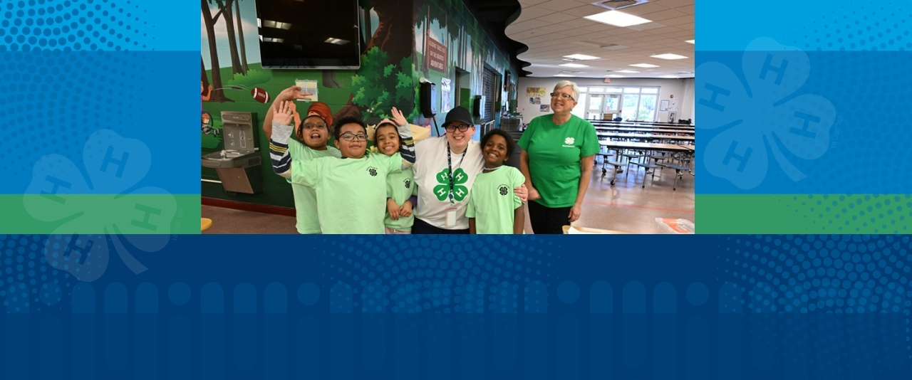 Elementary school children pose for a photo with 4-H Leaders.