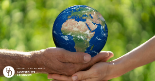 people holding a model of the earth