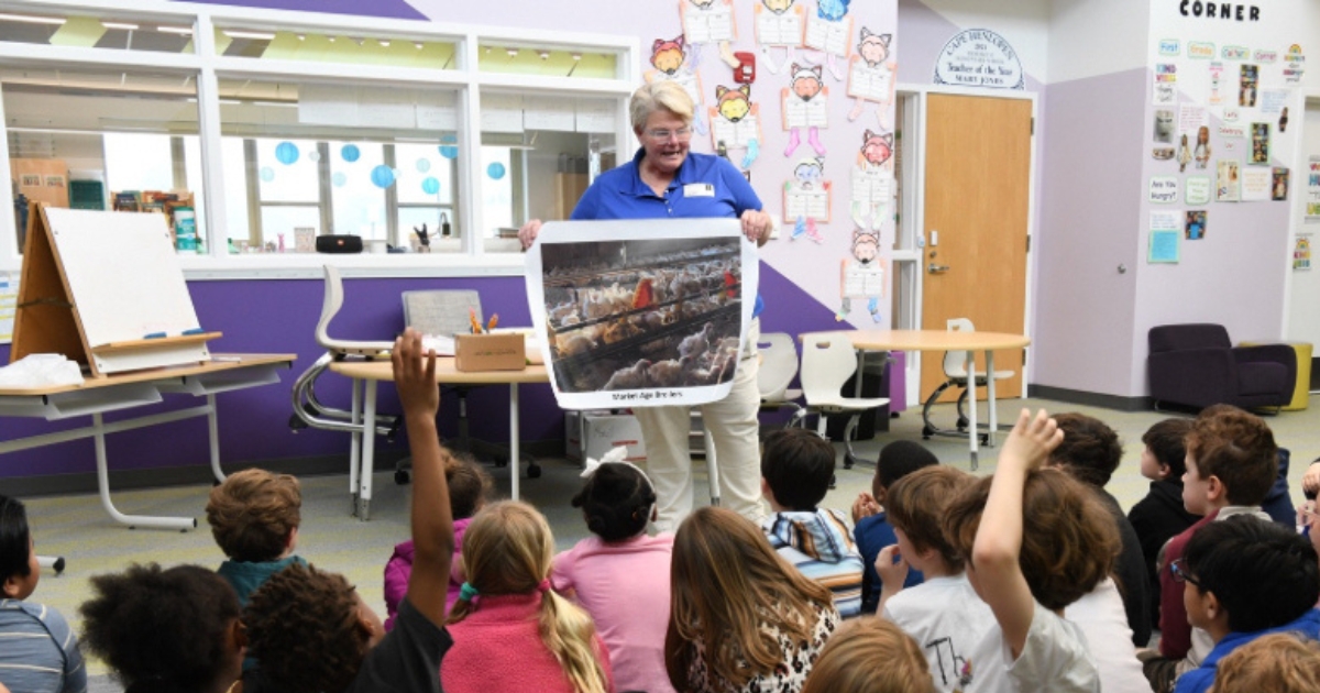 Georgie Cartanza, the University of Delaware Cooperative Extension poultry extension agent, stands in front of a elementary class.