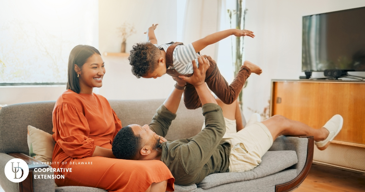 Two parents playing with their child