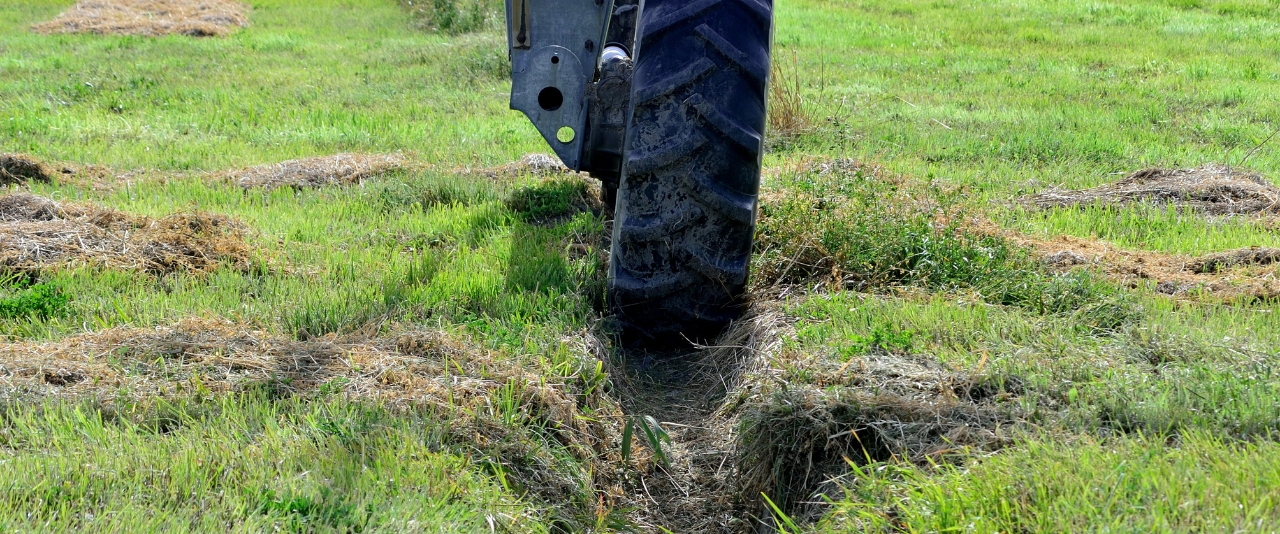 An irrigation wheel stuck in a muddy rut