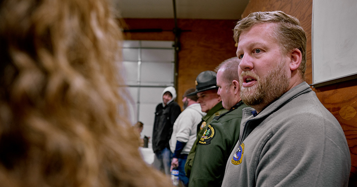 Joe Rogerson talking to someone at an event.