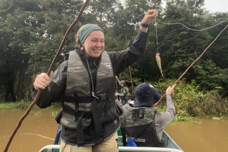 Olivia Frear holds up a piranha she caught during a fishing expedition on the Amazon River.