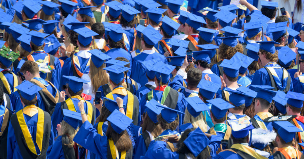 A sea of students in blue graduation garb.