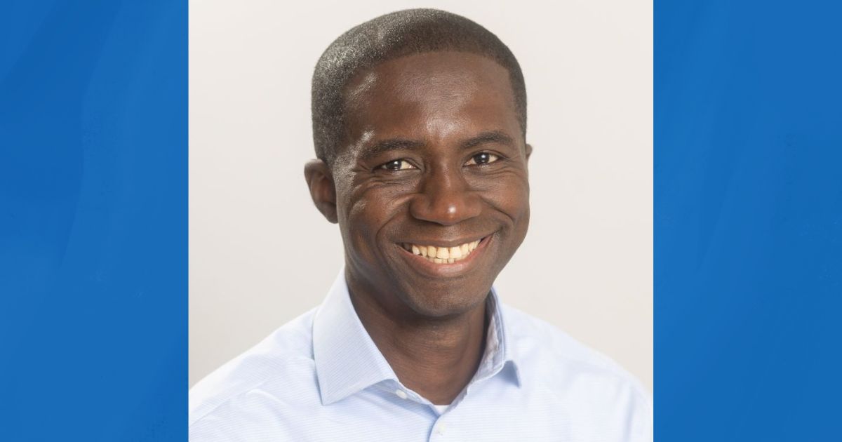 Kofi Britwum, with a blue background around him.