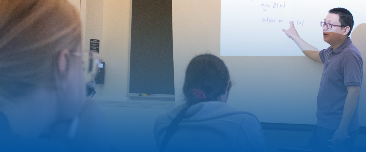 Professor teaching Statistics to students in the classroom.