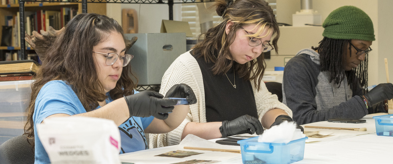 Art Conservation students restoring old photographs