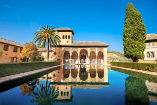 A Moorish-style 9th century tower with large reflecting pool in front. 