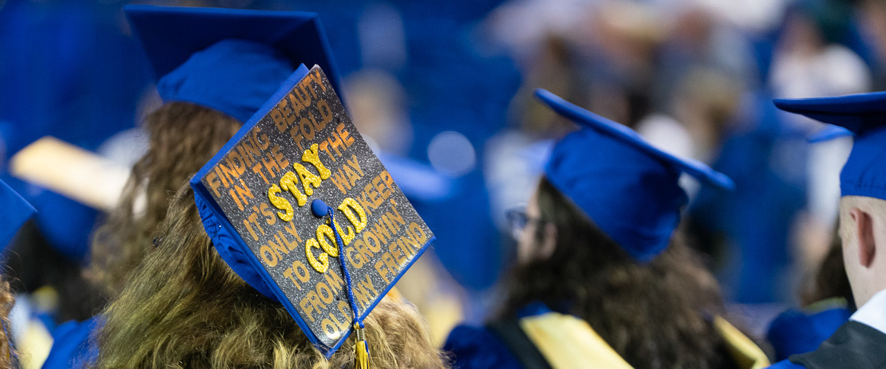 View of blue graduation caps at University of Delaware convocation