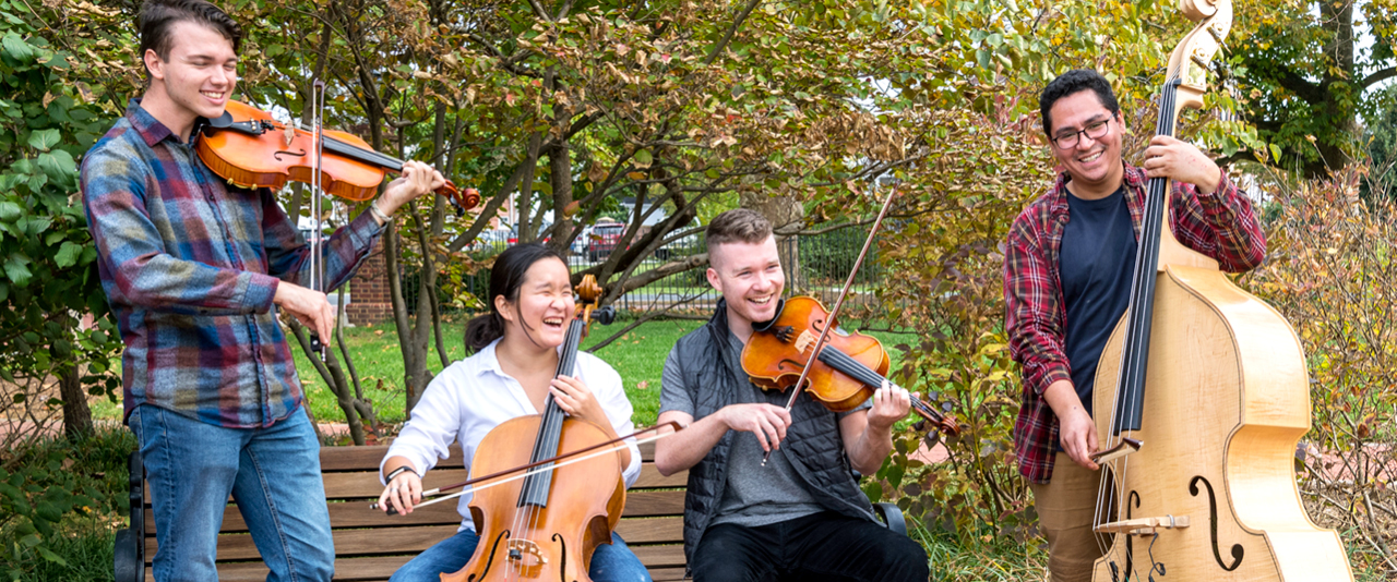 Students playing string instruments
