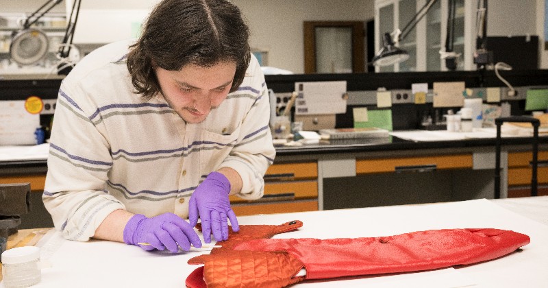 Student working on a coat