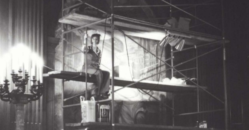Woman sitting on a scaffolding at the NY Public Library