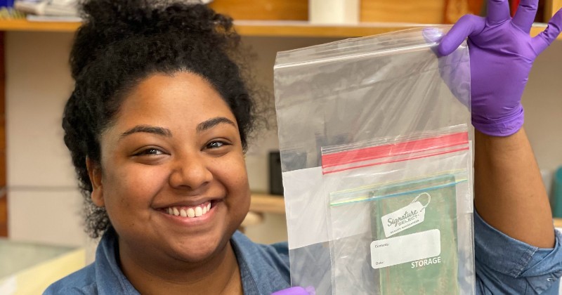 Brittany Murray holding a ziploc bag coontaining a book