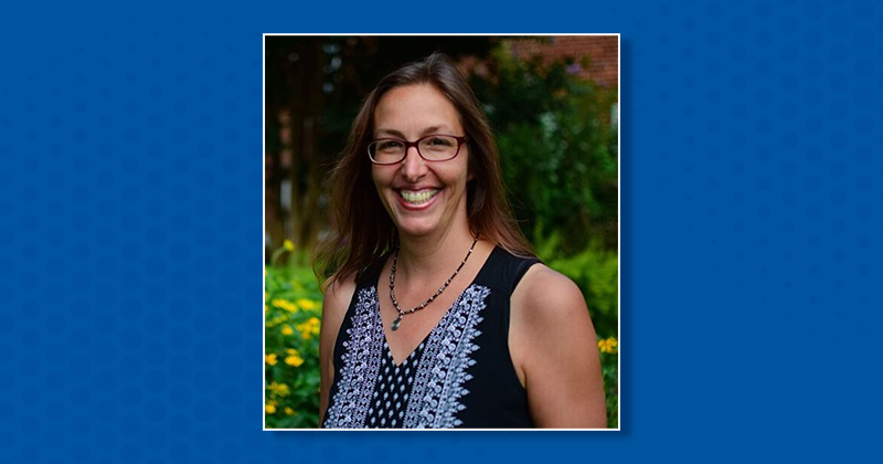 Headshot of Angela Seguin on blue background