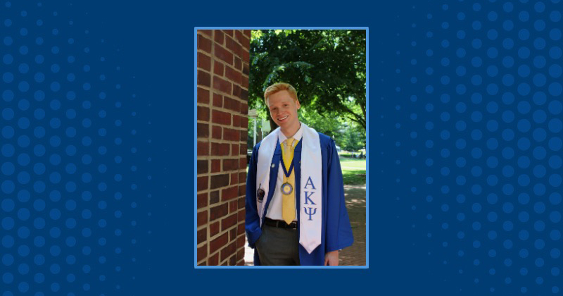 A photo of a college student in graduation regalia against a blue background.