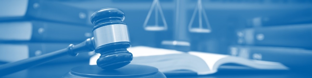 Blue gradient photo gavel and scales of justice near textbook