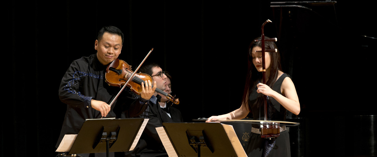 Violinists on stage performing