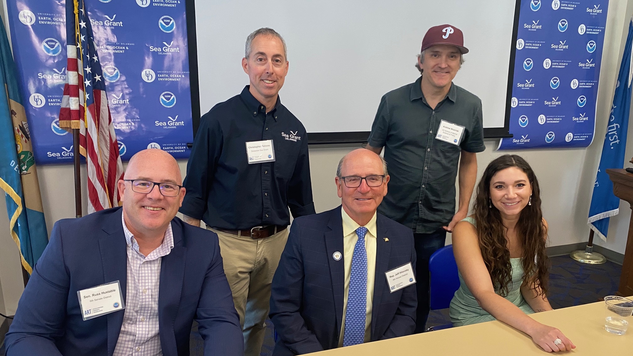 Seated, left to right, are Senator Russ Huxtable, Rep. Jeff Hilovsky, and Rep. Sophie Phillips. Standing are Chris Petrone and Andrew Wozniak. 