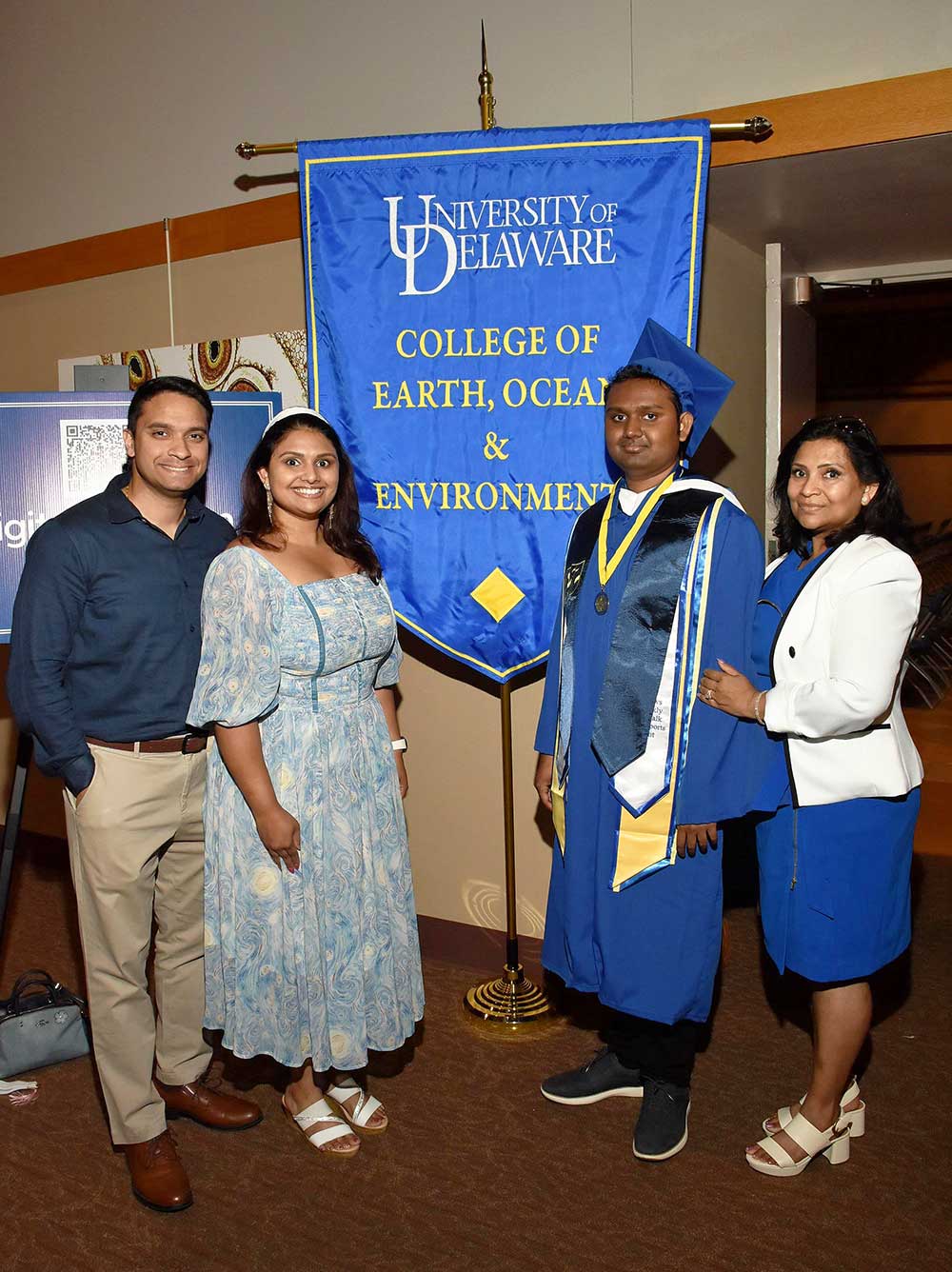 Family posing with the CEOE banner