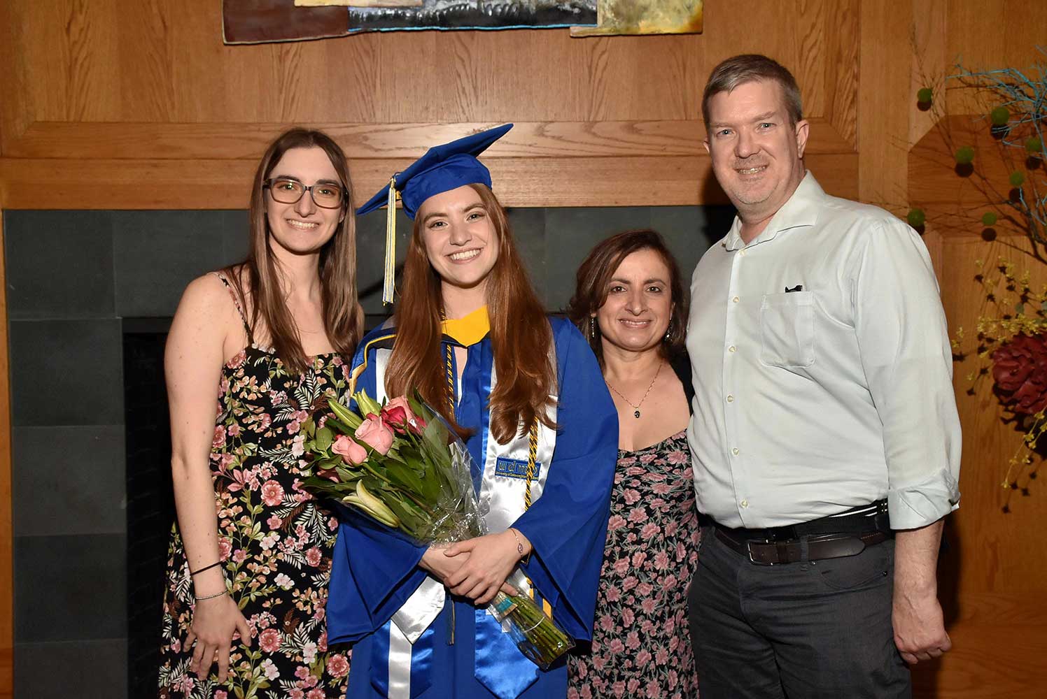 Recent graduate and family posing for photo