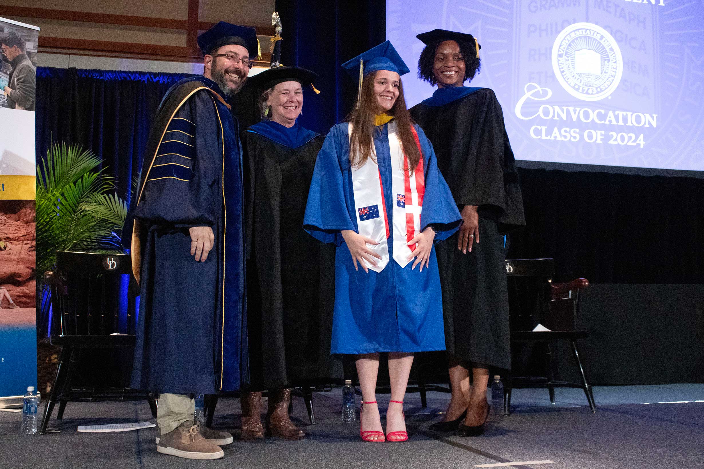   Recent graduate posing with CEOE leadership