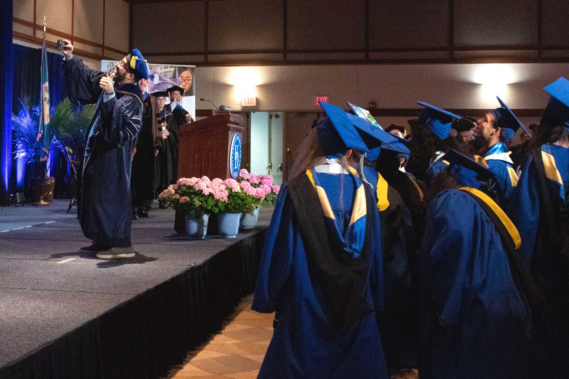 Dean Fabrice Veron taking a "selfie" with the graduates