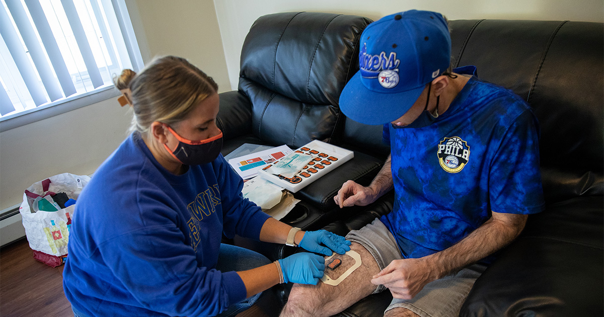 Health behavior science doctoral candidate Paige Laxton is equipping a resident of a group home with an activPAL as part of research on sedentary behavior in people with intellectual disabilities living in residential group homes.