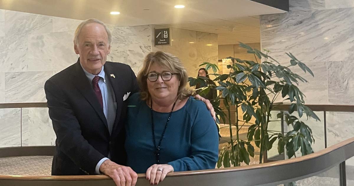 A man and a woman posing for a photo inside a government building